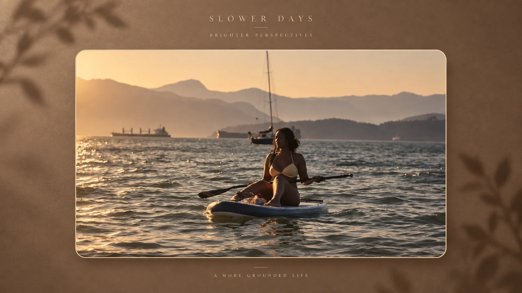 Sabrina paddleboarding on the water with mountains in the distance